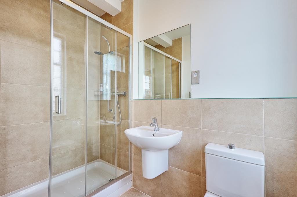 Lot: 6 - ATTRACTIVE TWO-BEDROOM APARTMENT IN CONVERTED FORMER HOSPITAL BUILDING - Tiled ensuite with double shower sink and toilet